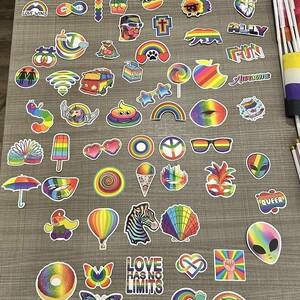 Photo of dozens of rainbow pride stickers in different shapes and sizes